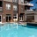 Resort-style swimming pool with lounge seating